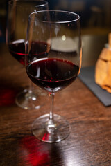 Dinner with glass of dry red wine in Italian osteria restaurant