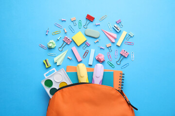 Back to school. Many different school stationery and paper planes on light blue background, flat lay