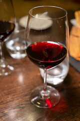 Dinner with glass of dry red wine in Italian osteria restaurant