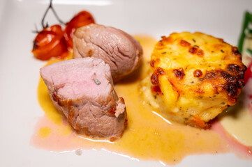 Degustation board with roasted beef and pork served with potato and vegetables