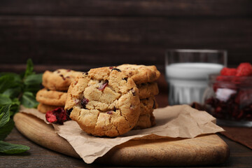 Cookies with freeze dried fruits and mint on wooden table, closeup