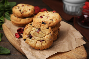 Cookies with freeze dried fruits and mint on wooden table, closeup
