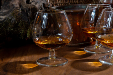 Tasting of aged french cognac brandy alcoholic drink in old cellars of cognac-producing regions Champagne or Bois, France