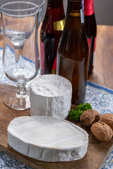 Belgian white mold soft cow milk cheeses Bouquet des Moines and creamy cheese and bottles of different Belgian beer