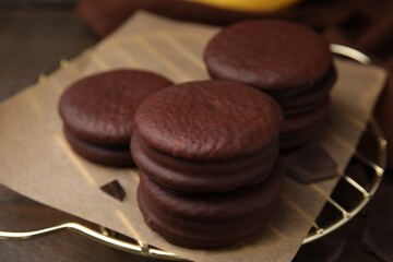 Delicious choco pies on wooden table, closeup
