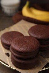 Delicious banana choco pies on wooden table, closeup