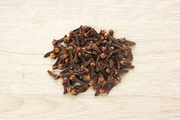 Dried cloves (cengkeh), dried herbs served in small bowl
