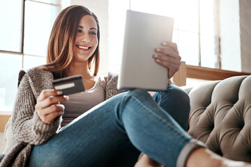 Happiness, tablet and credit card, woman on sofa in living room and internet banking or fintech in home. Technology, online shopping payment and girl on couch surfing retail website or digital shop.