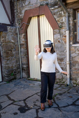asian girl using virtual reality glasses on the street