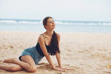 woman beach travel freedom sitting sand smile view nature sea back vacation