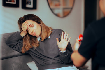 Unhappy Girlfriend Refusing Marriage Proposal from her Boyfriend. Unhappy woman embarrassed by unprompted engagement ring 
