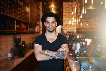 Portrait, smile and man with arms crossed, cafe and barista with startup success, restaurant and happiness. Face, happy male person and entrepreneur in a coffee shop, employee and business owner