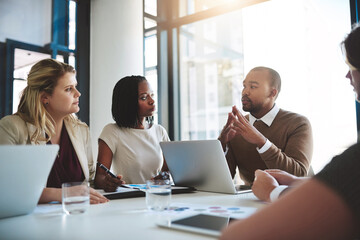 Business people, tech conversation and laptop data with planning and strategy in office. Training, communication and online job with management and working on a teamwork project with diversity