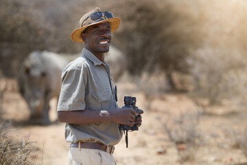 Portrait, safari and wildlife with a man ranger outdoor in a game park for nature conservation....