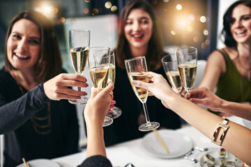 Food, party and champagne with friends at restaurant for celebration, wine and social event. Happy, diversity and toast with group of people eating together for fine dining, cheers and free time