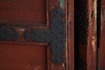 Iron detail on wooden doors in a historic Buddhist temple in Japan. Wabi-sabi.