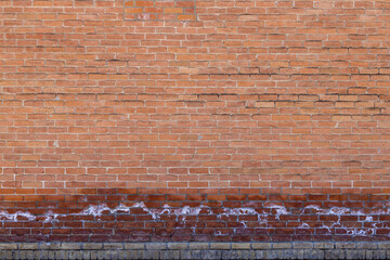 Full frame texture background of an antique exterior red brick wall with salt deposits from...