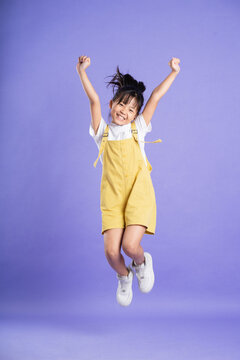 cute asian baby girl posing on purple background