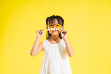 happy smiling asian baby girl on yellow background