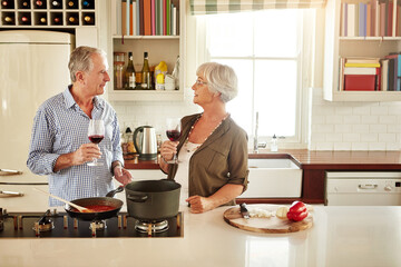 Wine, happy or old couple cooking food for a healthy vegan diet together with love in retirement at home. Smile, support or senior woman drinking or talking in house kitchen with husband at dinner