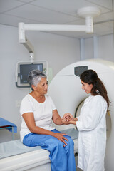 Doctor, mri and woman holding hands of patient in hospital before scanning in machine. Ct scan,...