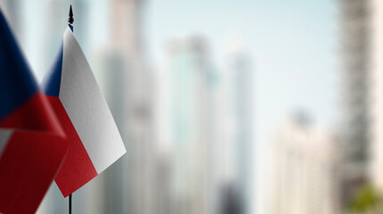 Small flags of the Czechia on an abstract blurry background