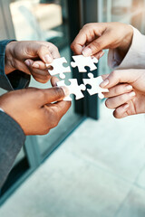 Closeup, hands and puzzle with collaboration, group and teamwork with partnership, planning and...