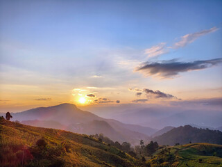 beautiful scenery during sunrise with fog covering the mountain