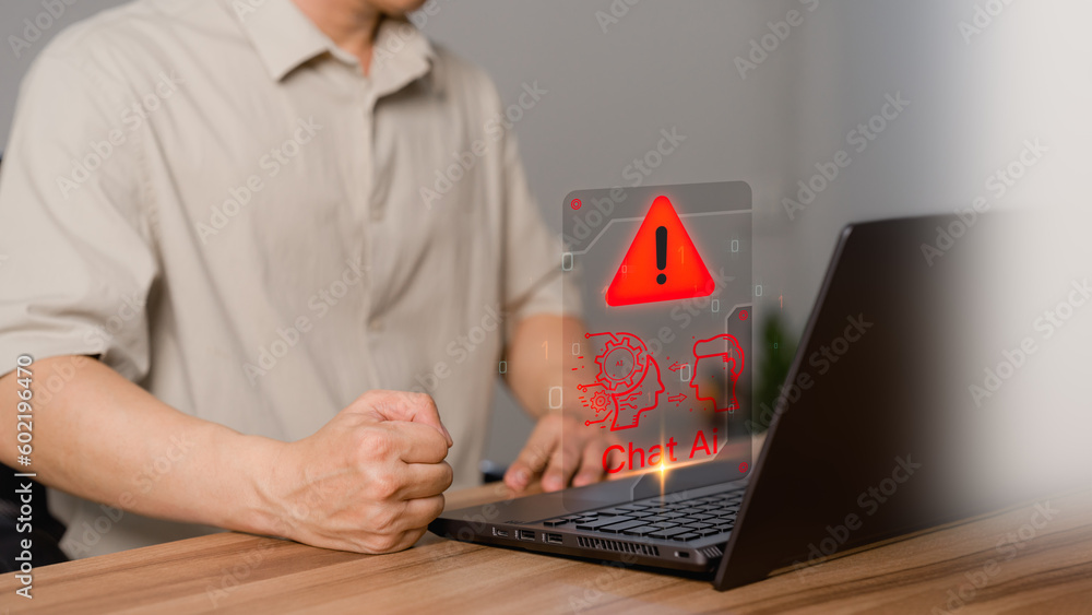 Fototapete Young man using laptop computer chatting with triangle caution warning sign for notification error concept. Chat with smart AI or Artificial Intelligence technology. Chat bot ai communication.