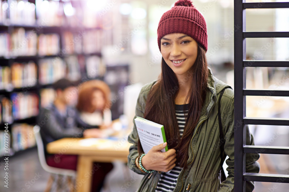 Poster woman in portrait, student in library with book and study for exam with smile on university campus. 