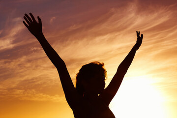 Silhouette, sunset and woman open arms and freedom outdoor, orange sky with fresh air and celebrate...