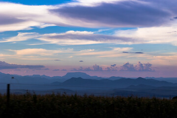 Fototapeta na wymiar Purple sunset behind the mountain mists of Kenya