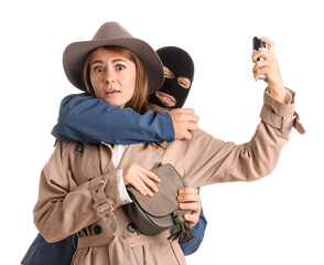 Young woman with pepper spray defending herself against thief on white background
