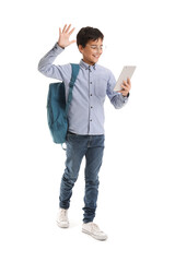 Little schoolboy using tablet computer on white background