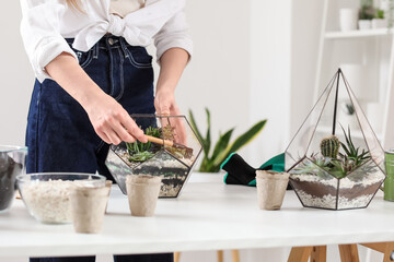 Woman making florarium at table, closeup