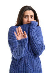 Scared young woman on white background