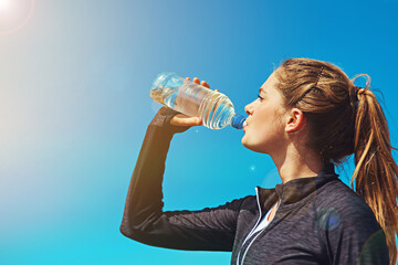 Woman drinking water, health and fitness with blue sky, athlete outdoor with hydration and mockup space. Sports, exercise and female person with h2o drink in bottle, workout and break from training - Powered by Adobe
