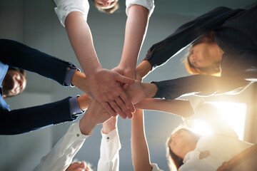 Hands together, support and business people in team with goals, solidarity and trust with professional community. Diversity, collaboration and corporate group in meeting in low angle and commitment