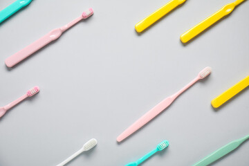 Plastic toothbrushes on grey background