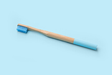 Bamboo toothbrush on blue background