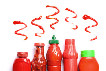 Ketchup squeezed out of bottles on white background