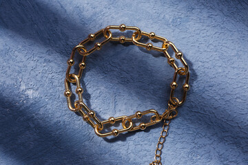 Fototapeta na wymiar Beautiful bracelet on blue grunge background