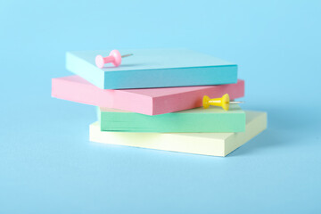Sticky notes and pins on blue background