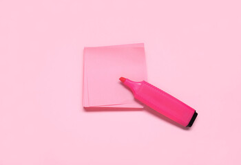 Sticky note with marker on pink background