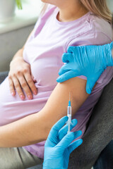 A pregnant woman makes a vaccination. Selective focus.