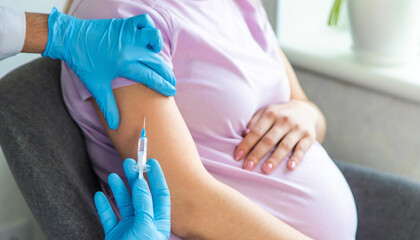 A pregnant woman makes a vaccination. Selective focus.