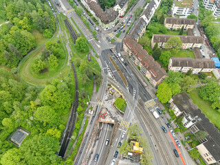 Top view of urban road with construction site and traffic on a cloudy spring morning at City of...