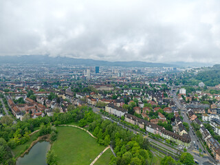 Obraz premium Aerial view of City of Zürich on a cloudy spring morning seen from public park named Irchel with cloudy sky background. Photo taken May 9th, 2023, Zurich, Switzerland.