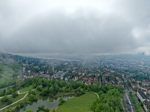 Aerial view of City of Z&uuml;rich on a cloudy spring morning seen from public park named Irchel with cloudy sky background. Photo taken May 9th, 2023, Zurich, Switzerland.