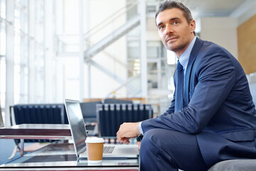 CEO or business man thinking in airport with laptop for invest strategy, stock market finance or financial review. Corporate professional waiting on sofa with tech doing research on economy